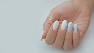 Delicate light manicure with sequins, for a wedding or holiday.